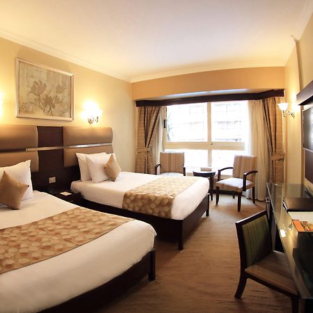 Pyramisa Suites Hotel Cairo Giza Exterior photo A room at the hotel