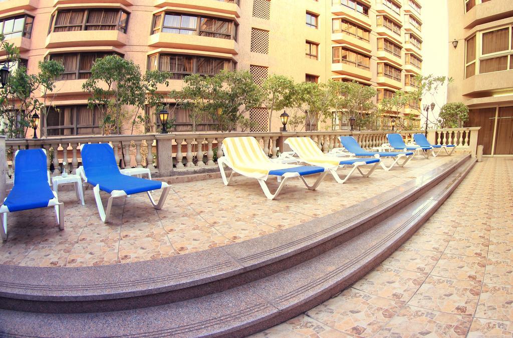 Pyramisa Suites Hotel Cairo Giza Exterior photo A balcony of a modern apartment in Dubai
